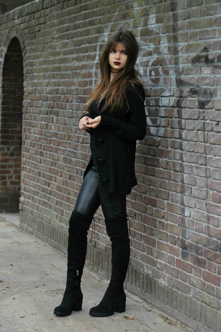 Over the knee boots in all-black outfit